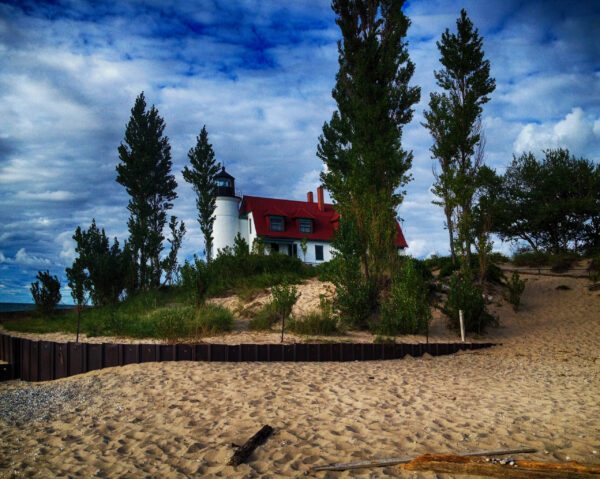 The Frankfort Lighthouse captured by Ken Osborne, standing as a beacon on the sandy shores