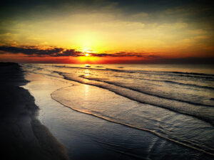 Sunrise over the ocean, a photograph by Ken Osborne