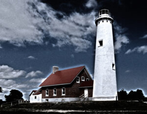 Stark white Michigan lighthouse with a vivid red roof, standing against a dynamic sky.