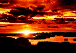 Intense red and orange sunset over Galveston's waterfront, captured by Ken Osborne.