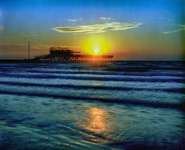 Sunrise hues illuminate the Galveston Fishing Pier in this Ken Osborne photograph