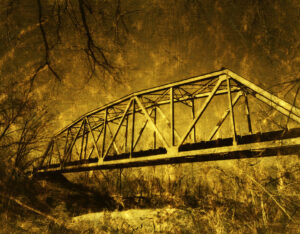 Golden-toned photograph of a vintage bridge by Ken Osborne, blending nostalgia with modern artistry.