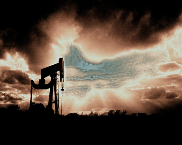 "Silhouette of an oil rig against a fiery sunset sky, embodying the power of industry."