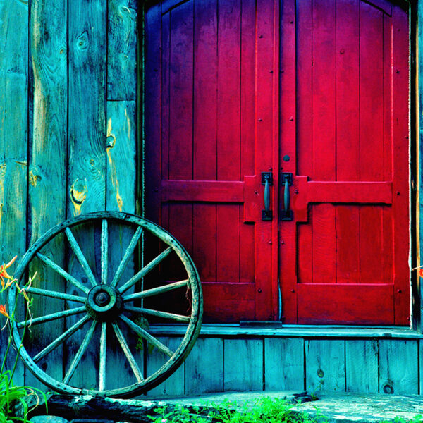 Rustic red barn door with vintage wagon wheel - Rustic Elegance