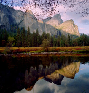 Yosemite National Park cliffs reflected in the calm river at dawn