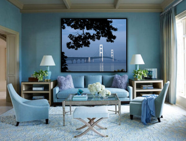 "Mackinac Bridge Morning Haze" - The serene image of the Mackinac Bridge enveloped in morning mist, displayed in a tranquil living room setting.