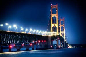 Illuminated Mackinaw Bridge at dusk by Ken Osborne