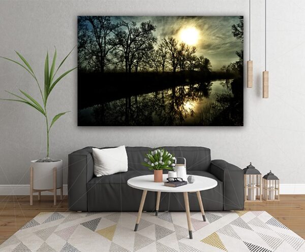 "Serene Reflections at Bessie’s Creek" - A tranquil panoramic photograph hanging above a couch, illustrating the serene beauty of a reflective waterscape at dusk.